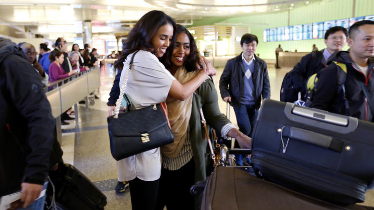 people hugging in airport