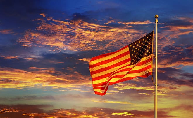 US Flag - flag flying in the sky with clouds in the background