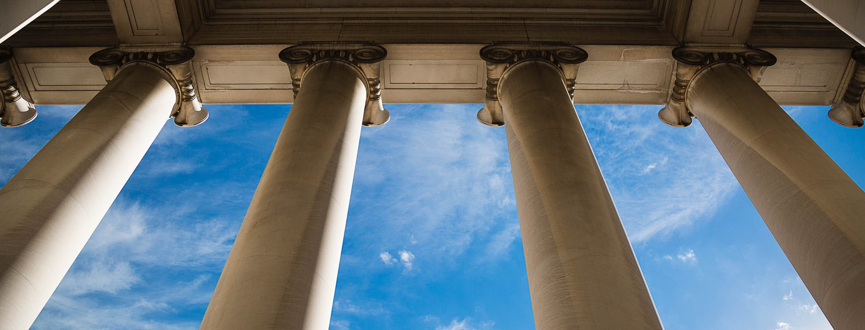 First Amendment Banner - courthouse columns looking up into blue sky