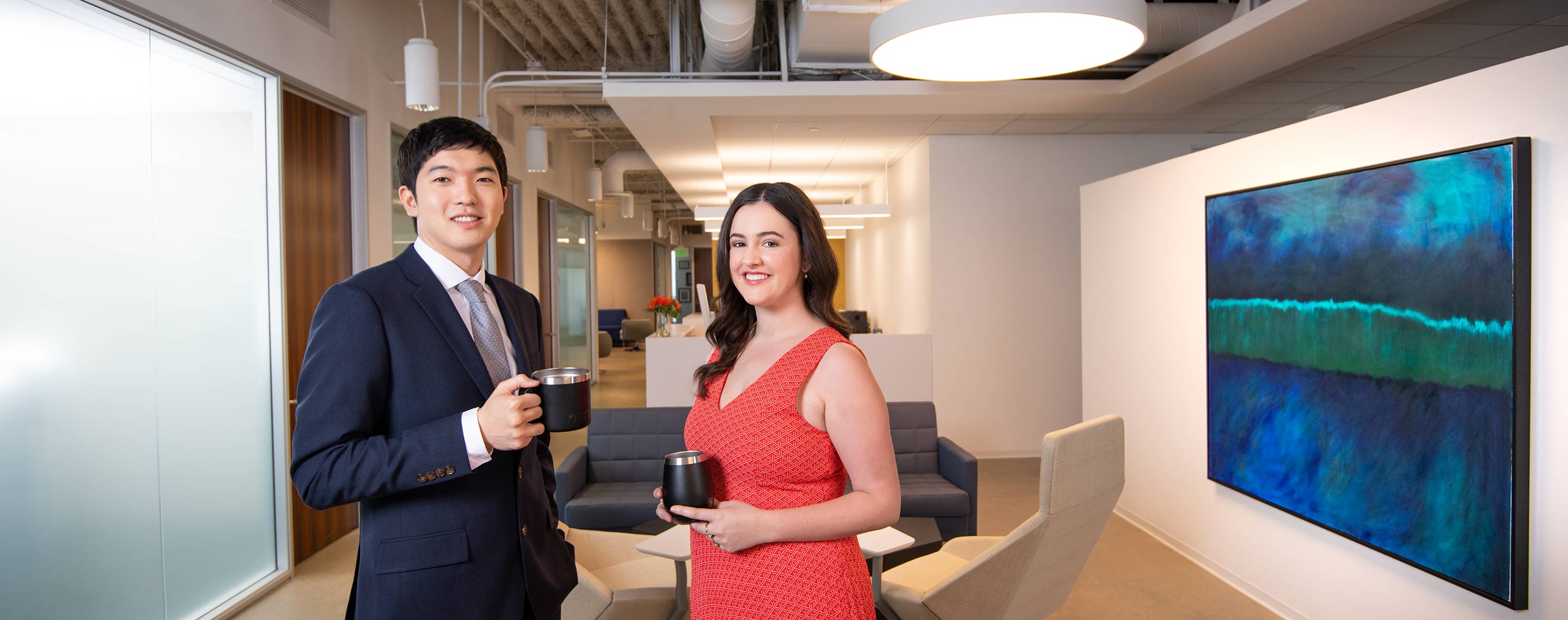 Trial Fellows Image - Picture of two people standing in office drinking coffee